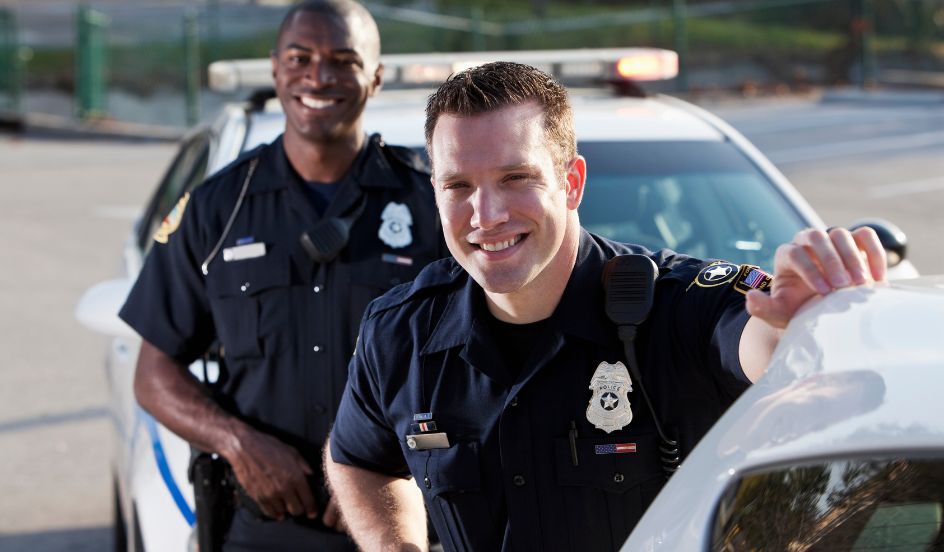 police officers standing in front of police cars