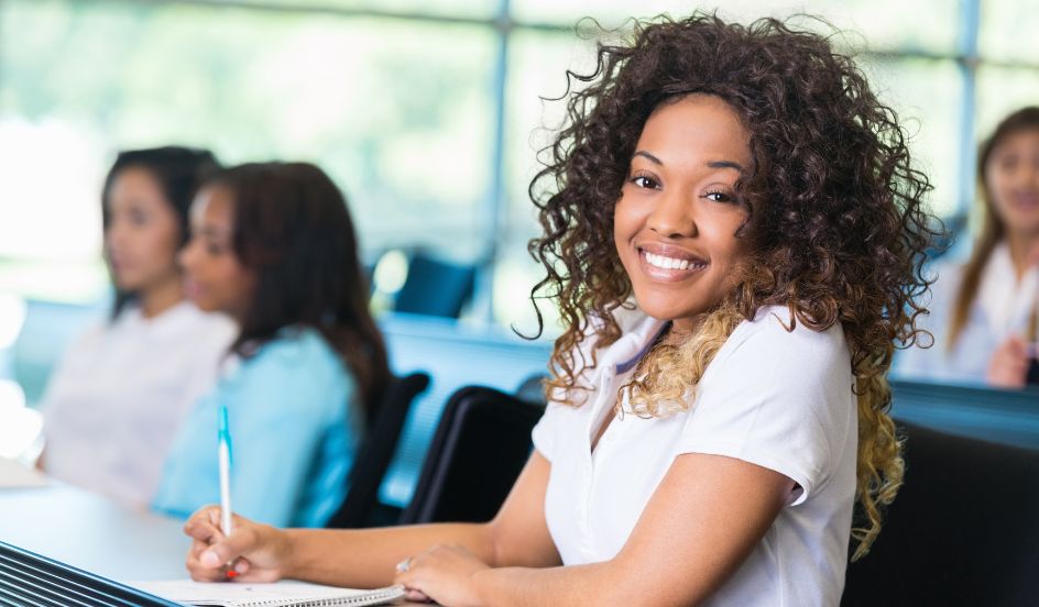 woman taking notes in class