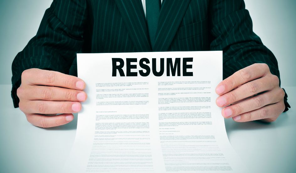 person holding up a resume