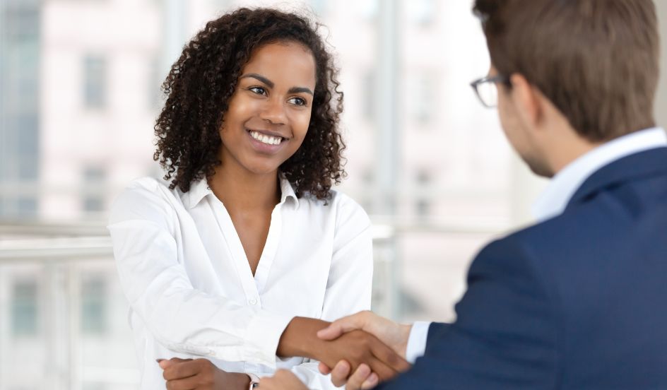 woman in interview after program placement shaking hands