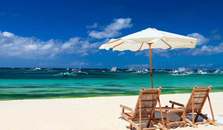 beach chairs with open umbrella on a beach