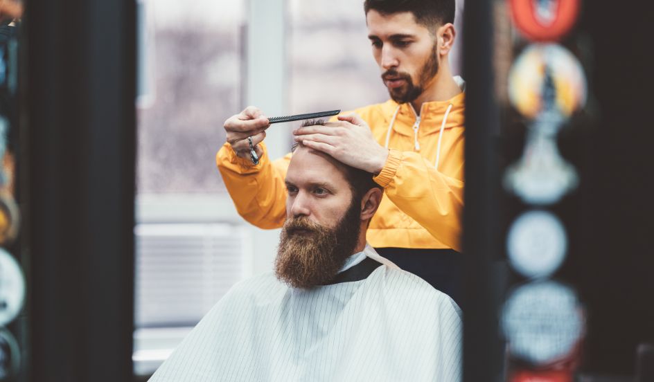 barber cutting a mans hair