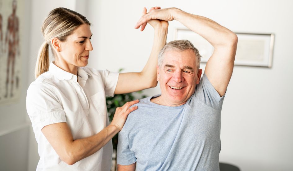 physiotherapy assistant helping senior male