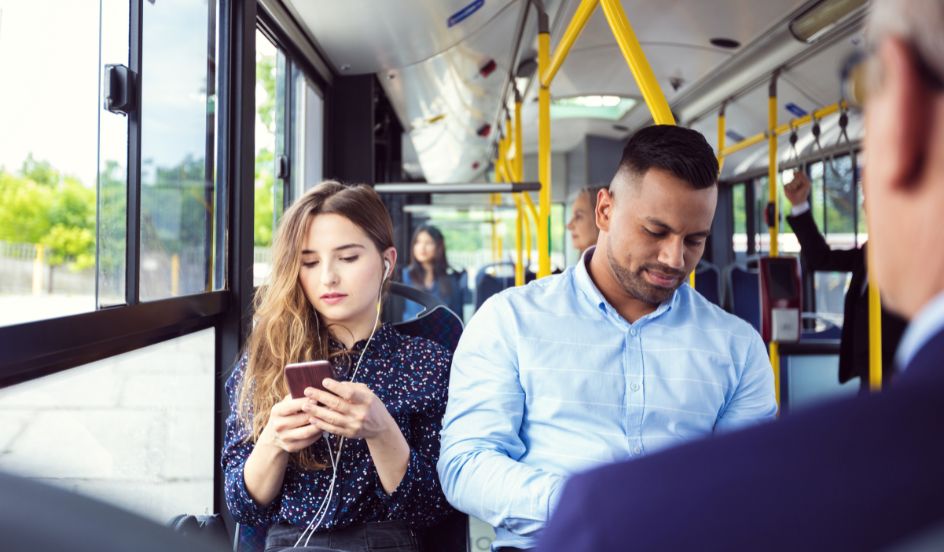 woman using phone while commuting to school