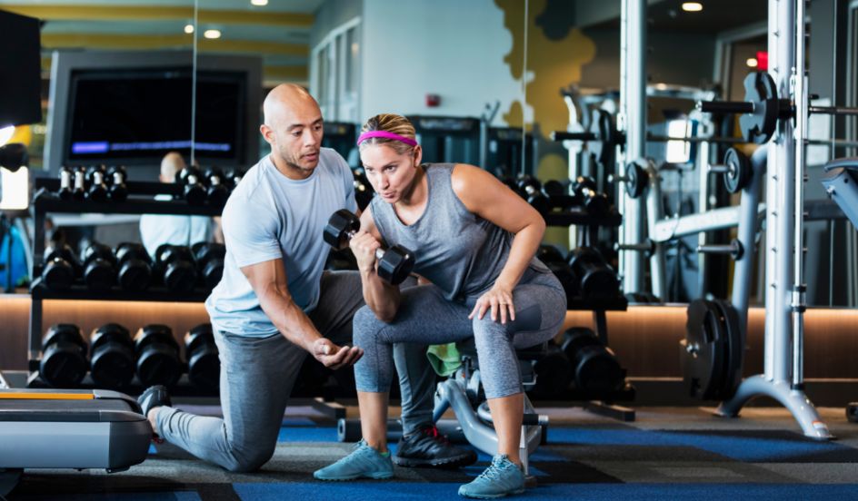 fitness coach working with client