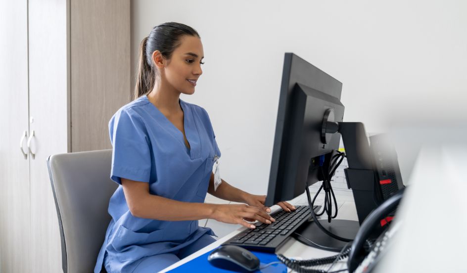 medical transcriptionist typing on computer