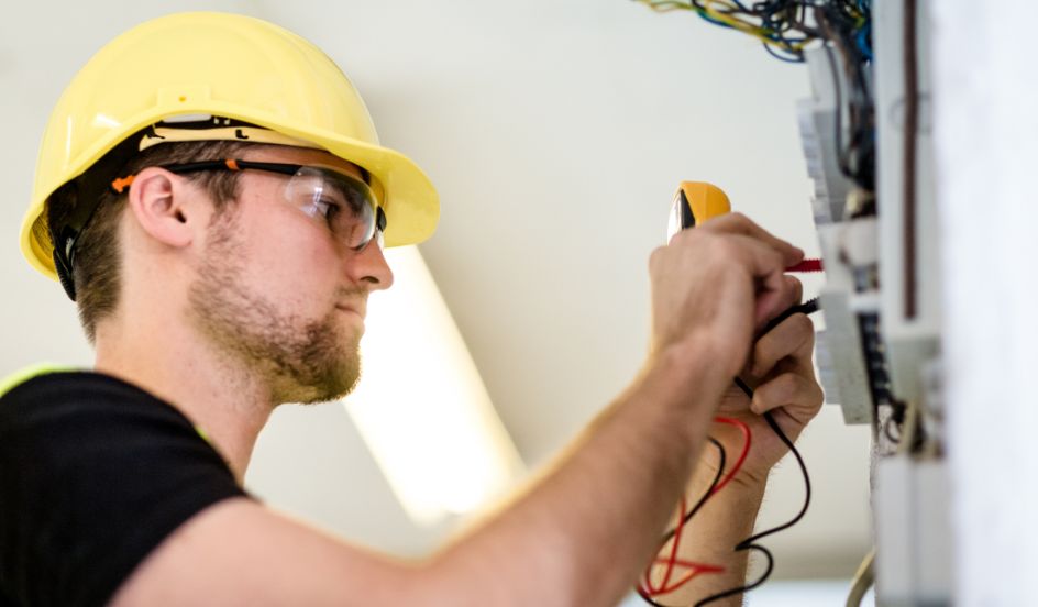 electrician repairing and testing an electrical panel