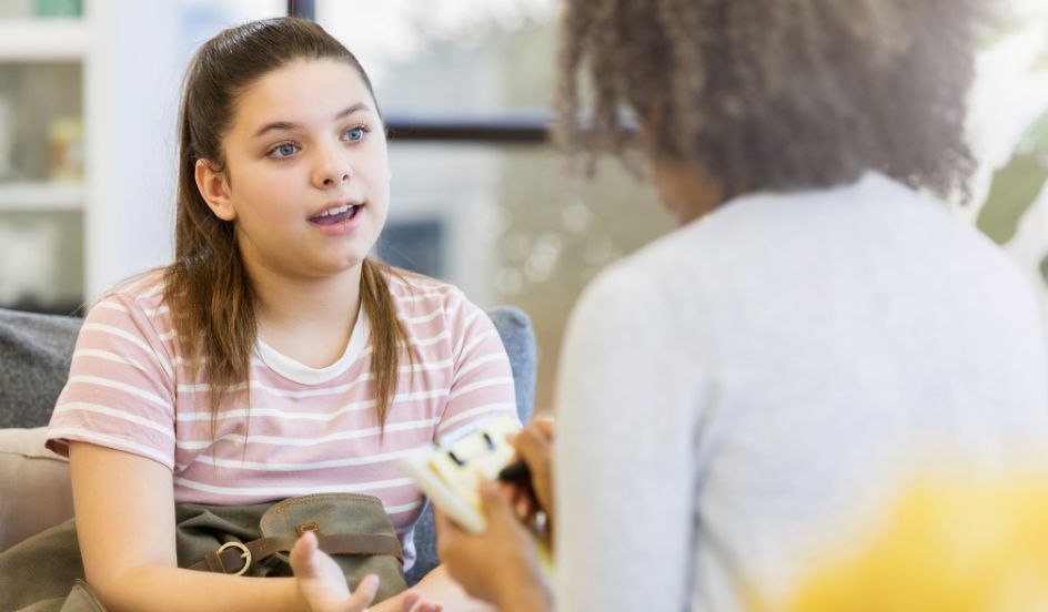 youth talking with a child and youth care worker