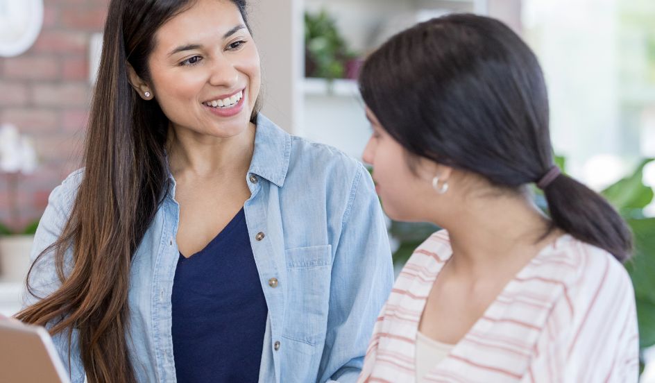 child and youth care working talking to a teen