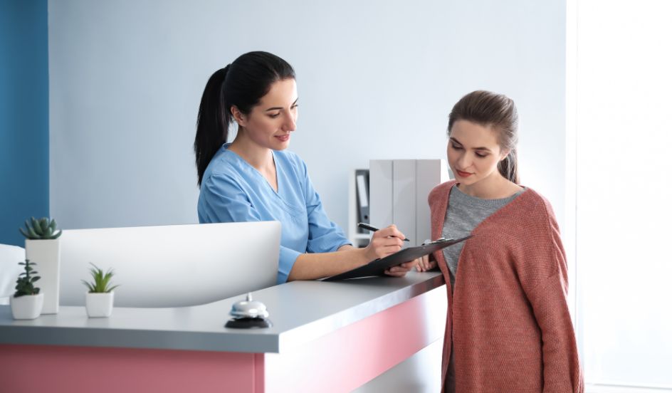 medical office assistant helping a patient