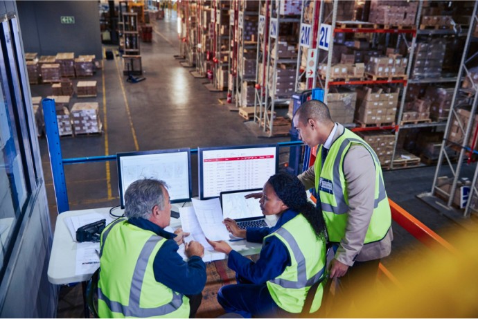 A supply chain and logistics manager explains to his coworkers