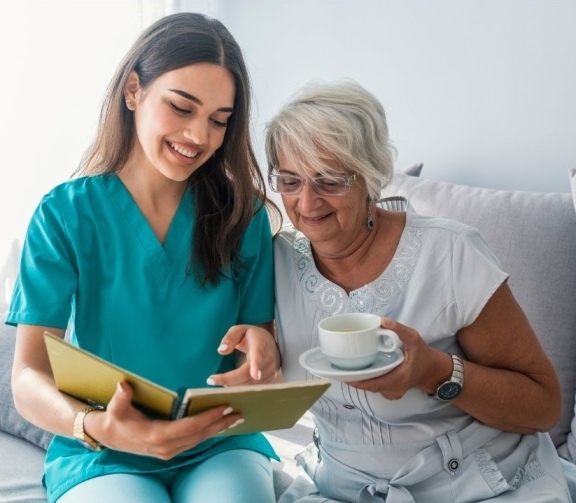 Continuing care assistant attends to her client.