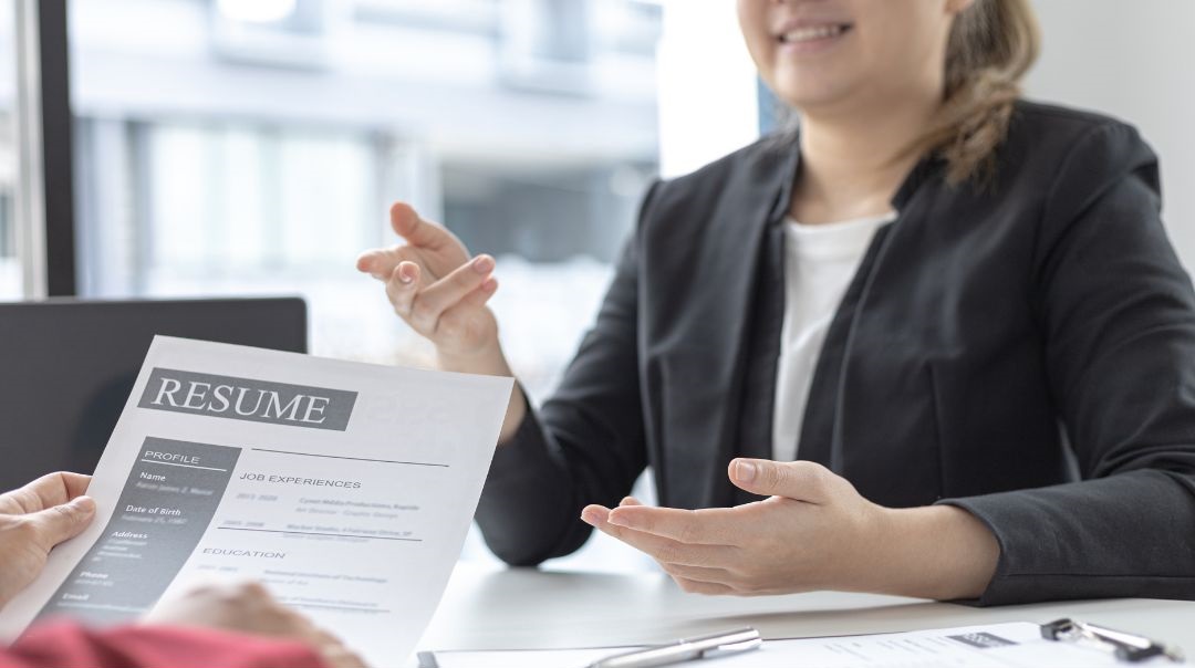 Woman explaining her resume during an interview.