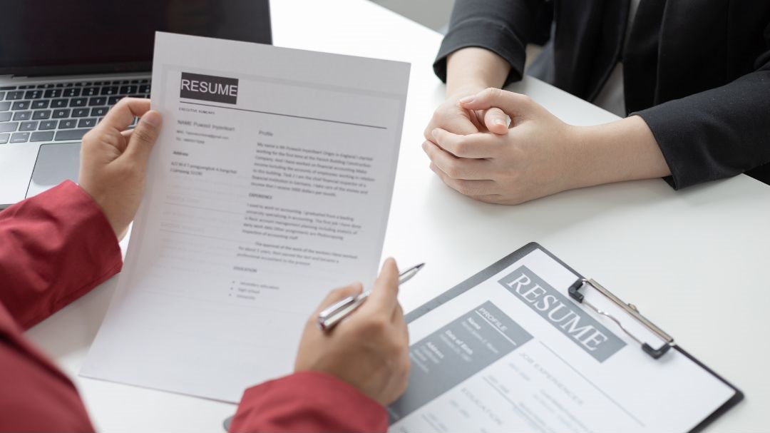 Holding a resume paper during an interview.
