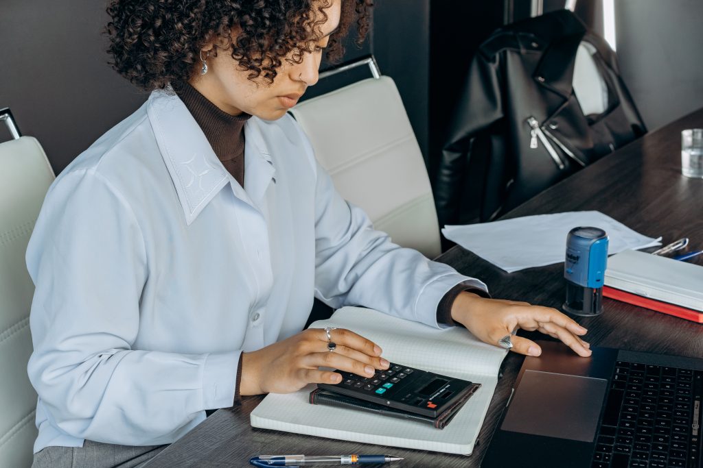 Accounting-Technician-With-Calculator-at-Desk